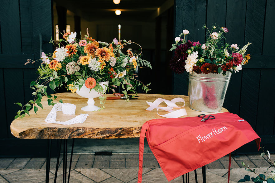 Flower Haven bouquets and apron on a rustic table