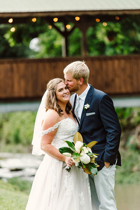 Bride and groom with magnolia bouquet